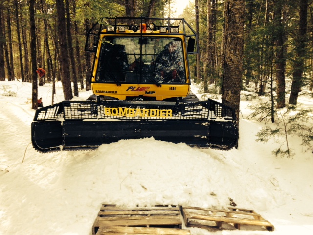 Pushing snow to fill in a brook crossing on the new 109 trail